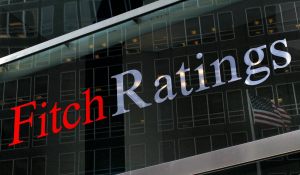 File photo of a flag reflected on the window of the Fitch Ratings headquarters in New York