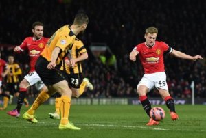 manchester-uniteds-english-striker-james-wilson-r-shoots-to-score-a-goal-during-the-fa-cup-fourth-round-replay-football-match-between-manchester-united-and-cambridge-united-in-manchester-england-on-february-3-2015